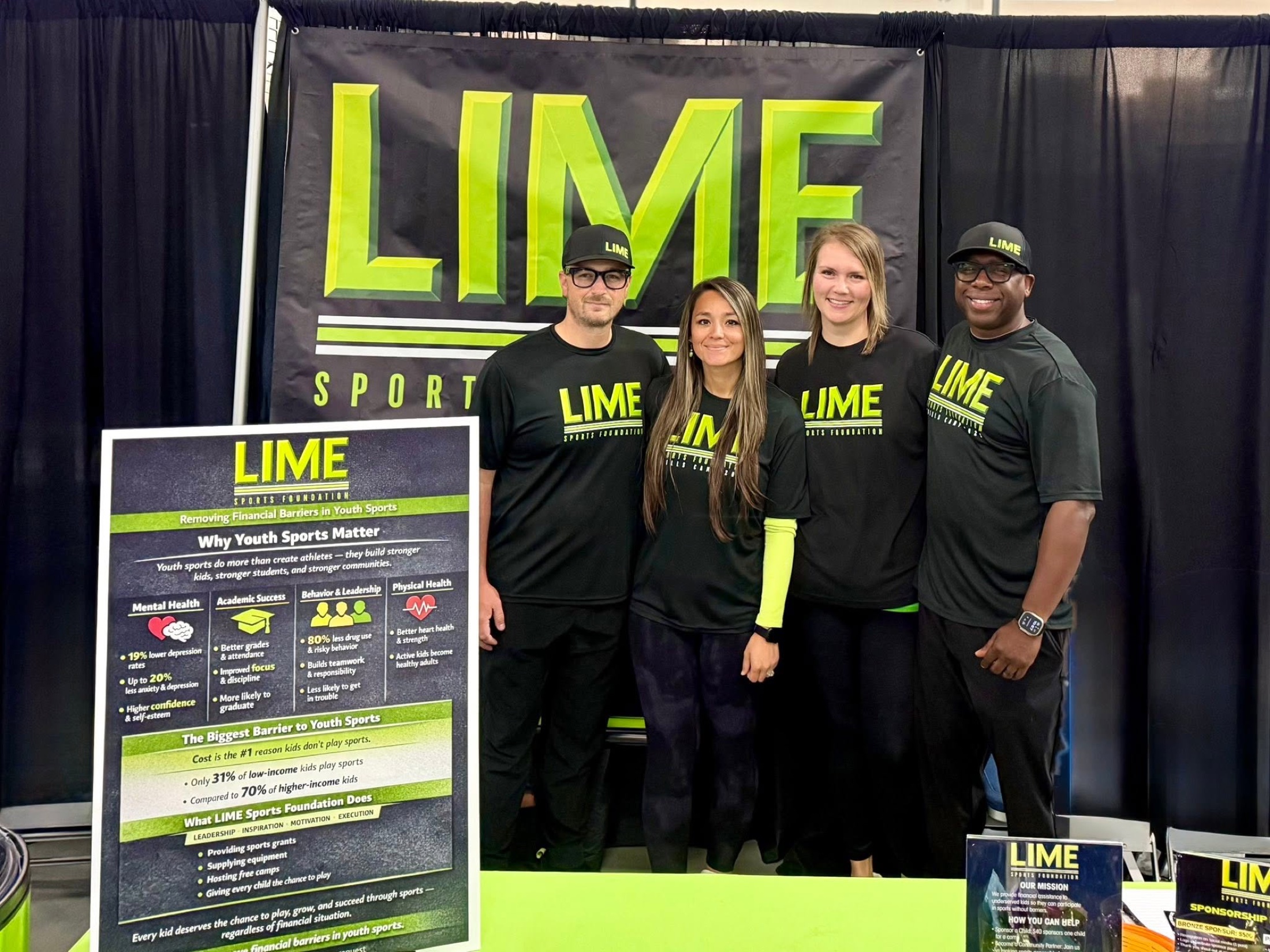 Four LIME Sports Foundation team members at a community outreach booth
